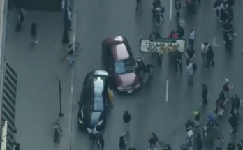 Car drives through anti-ICE protesters as Chicago joins nationwide anti-ICE unrest amid Trump crackdown